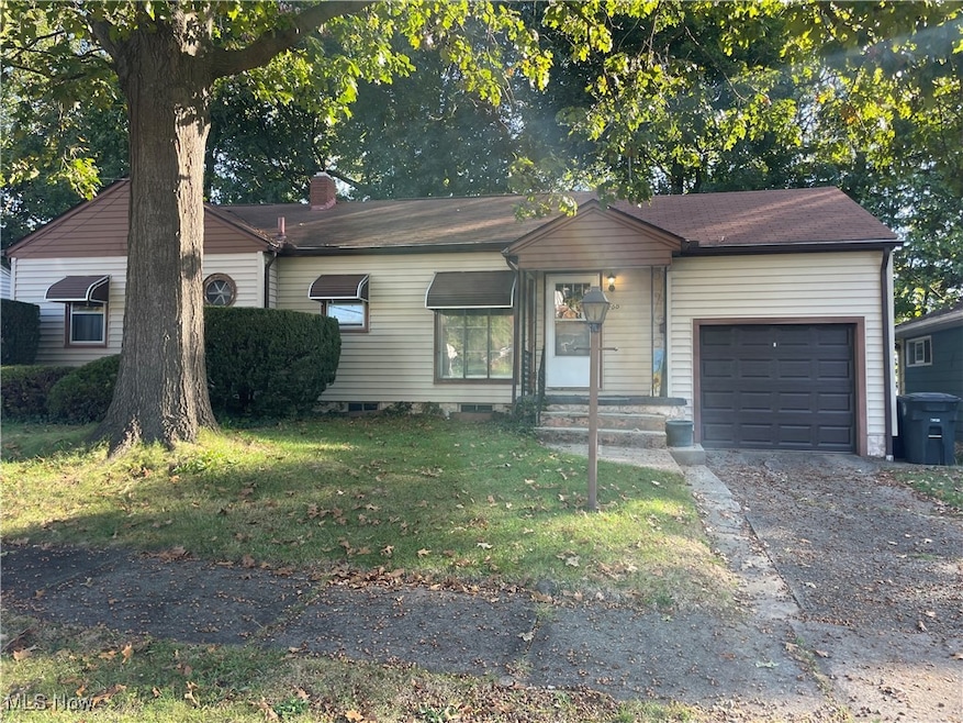Single story home with a front yard, an attached garage, driveway, and a chimney