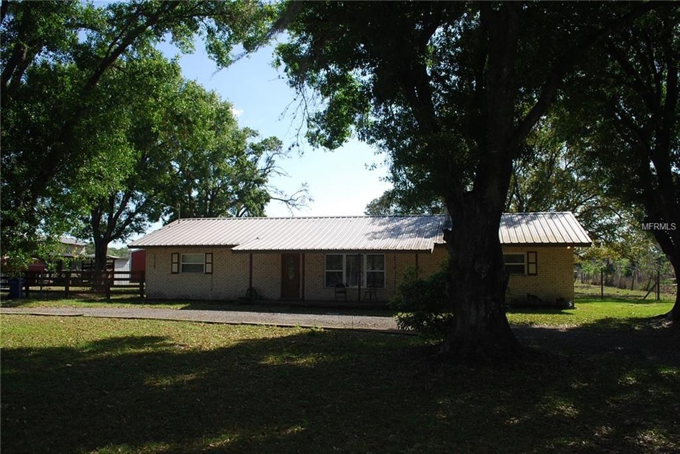 Front view with covered porch. Circle driveway.