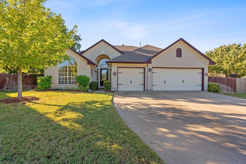 Single story home featuring concrete driveway, br