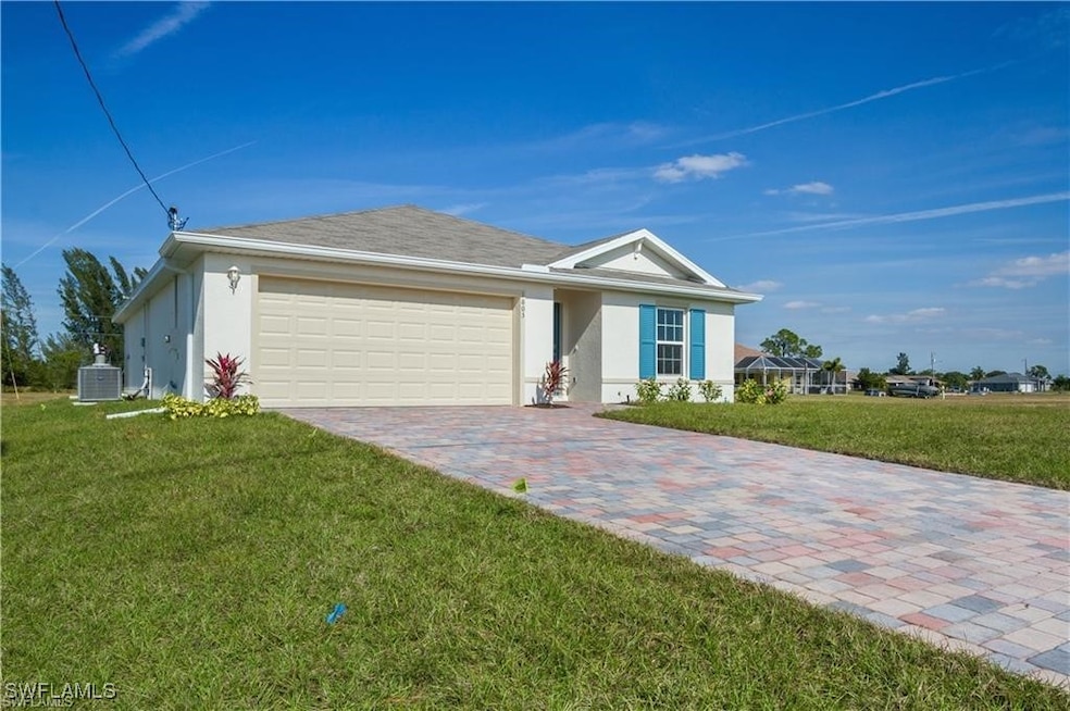 Ranch-style home featuring a garage, cooling unit,