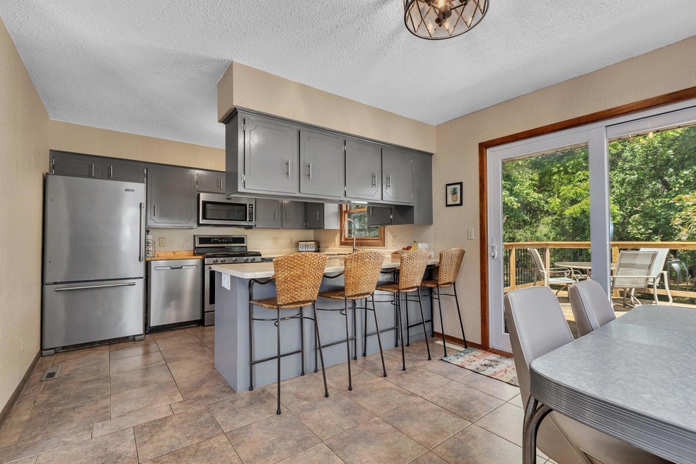 Well lit kitchen with tiled flooring
