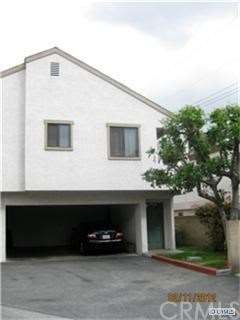 Front view of condo and covered car port space