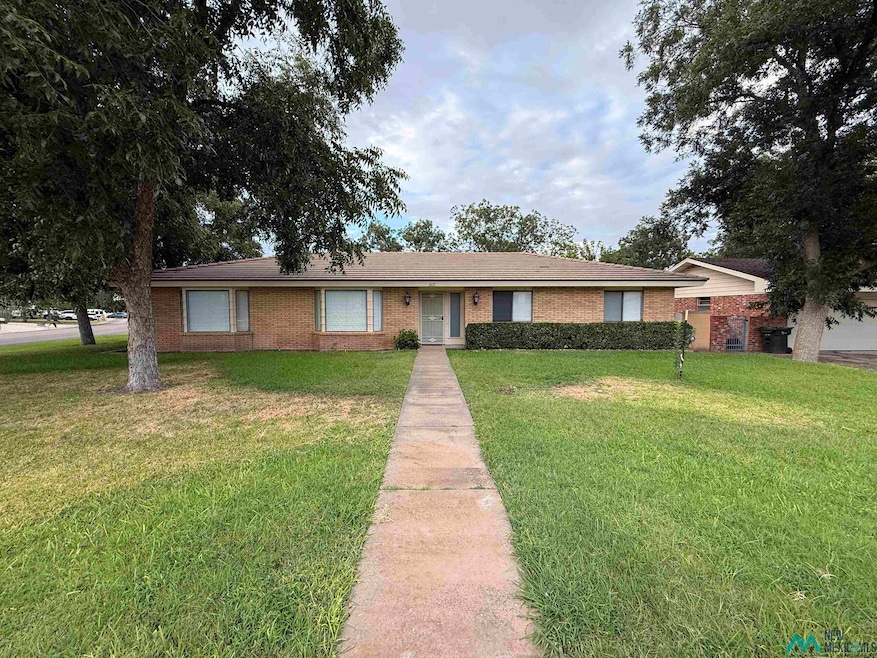 Ranch-style home featuring a front lawn and brick siding