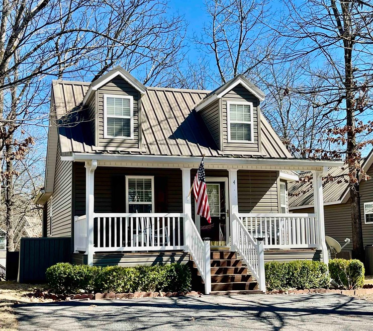 View of front of house with covered porch and meta