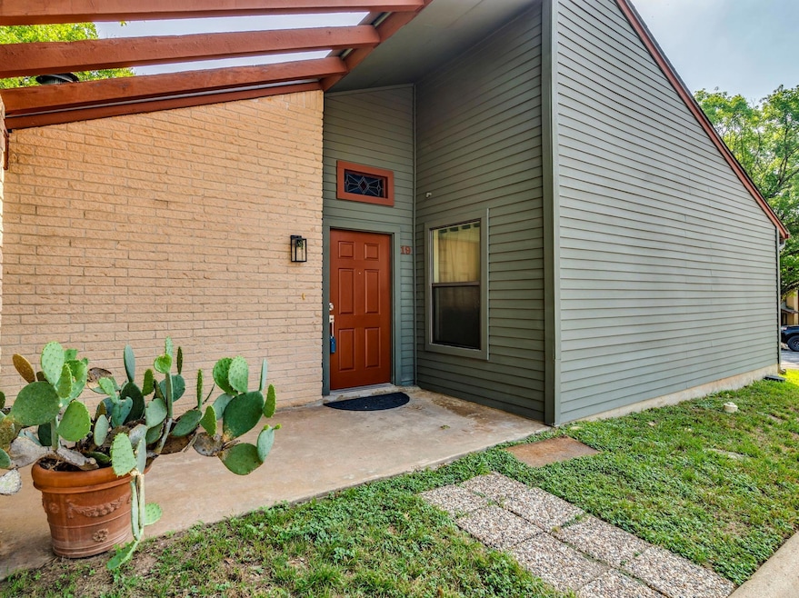 View of exterior entry featuring brick siding