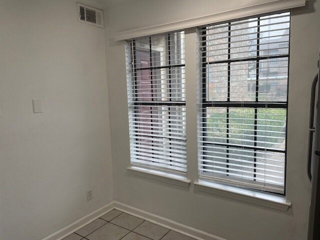 Detailed view of baseboards and freestanding refrigerator