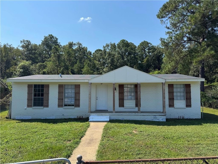 Ranch-style house featuring brick siding and a porch