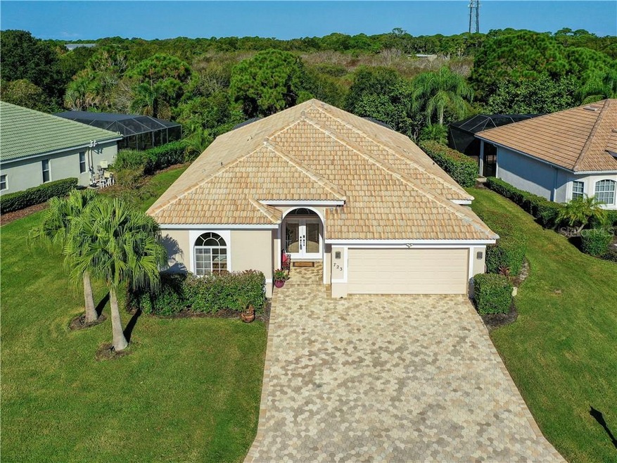 Curb appeal tile roof and 3-car deep brick paver d