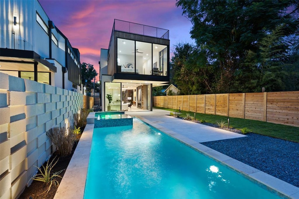 Back of house at dusk with a fenced backyard, a p