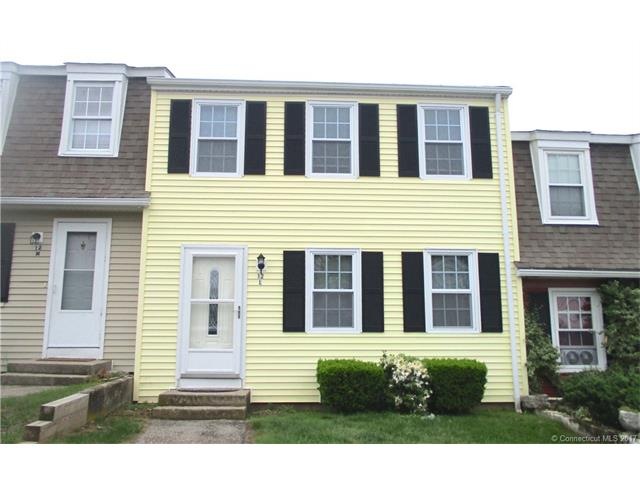 Beautiful pale yellow townhouse stands out from th