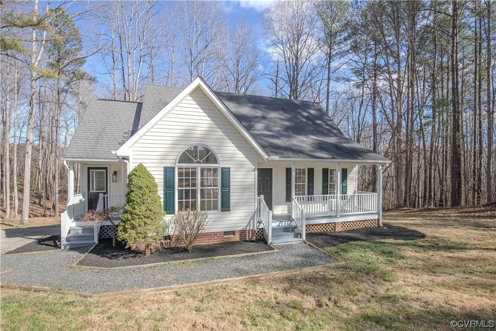 View of front of property featuring a front yard and covered porch