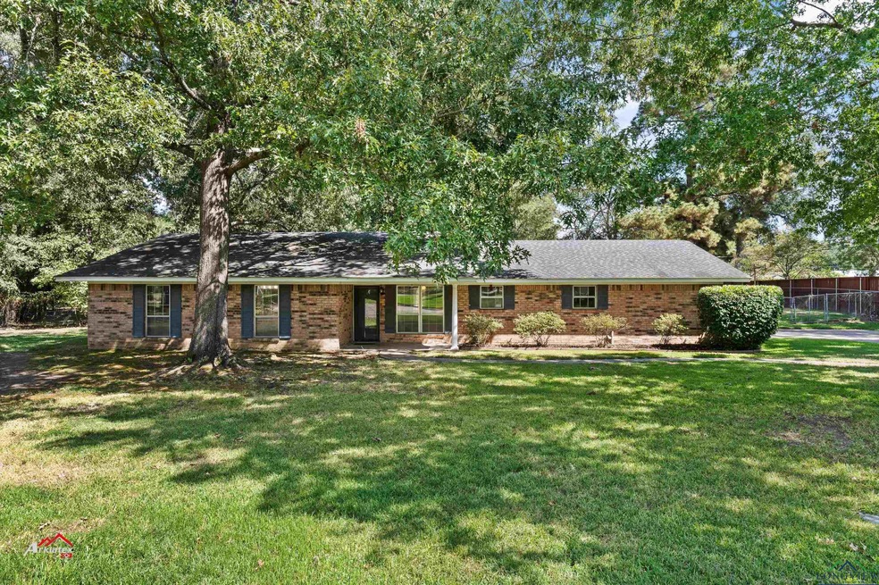 Ranch-style home featuring a front yard