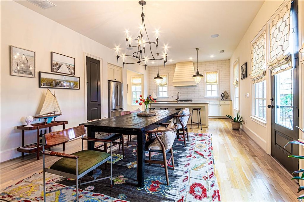 Dining room with a chandelier, sink, and light hardwood / wood-style flooring