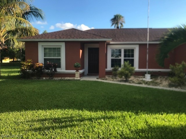 Single story home with a front lawn