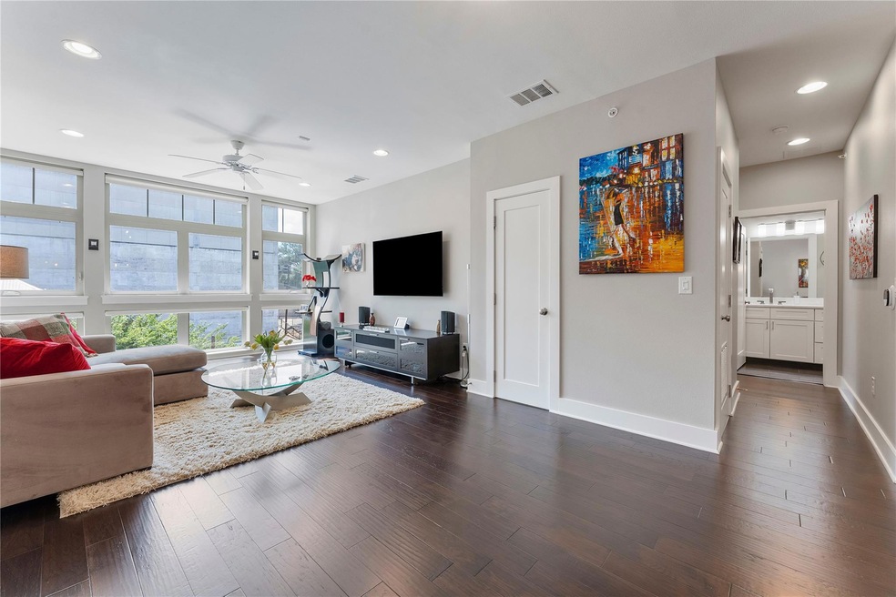Living room with dark wood-type flooring, recesse