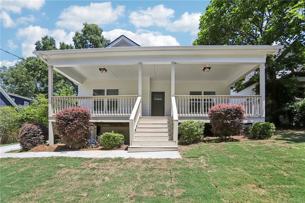 View of front of house with a porch and a front yard