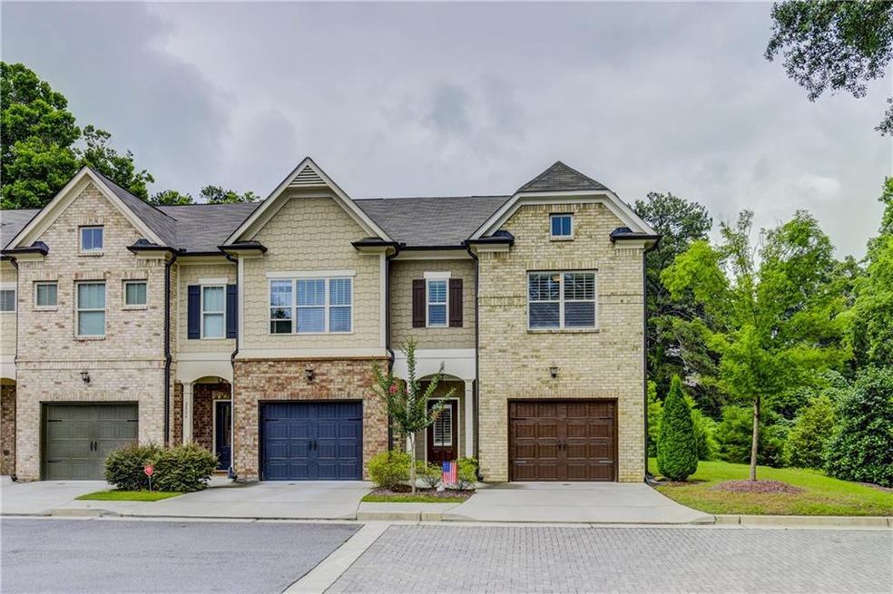 This end unit features a large side yard and lush 