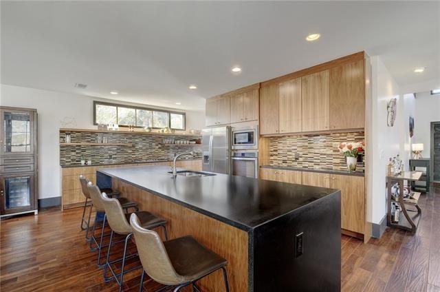 Custom built walnut cabinetry creates tons of stor