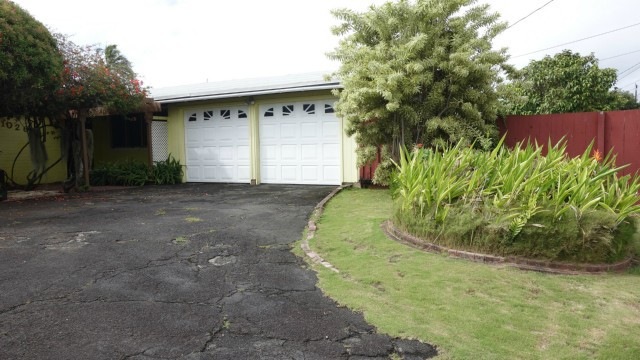 Two car enclosed garage with lots of parking in th