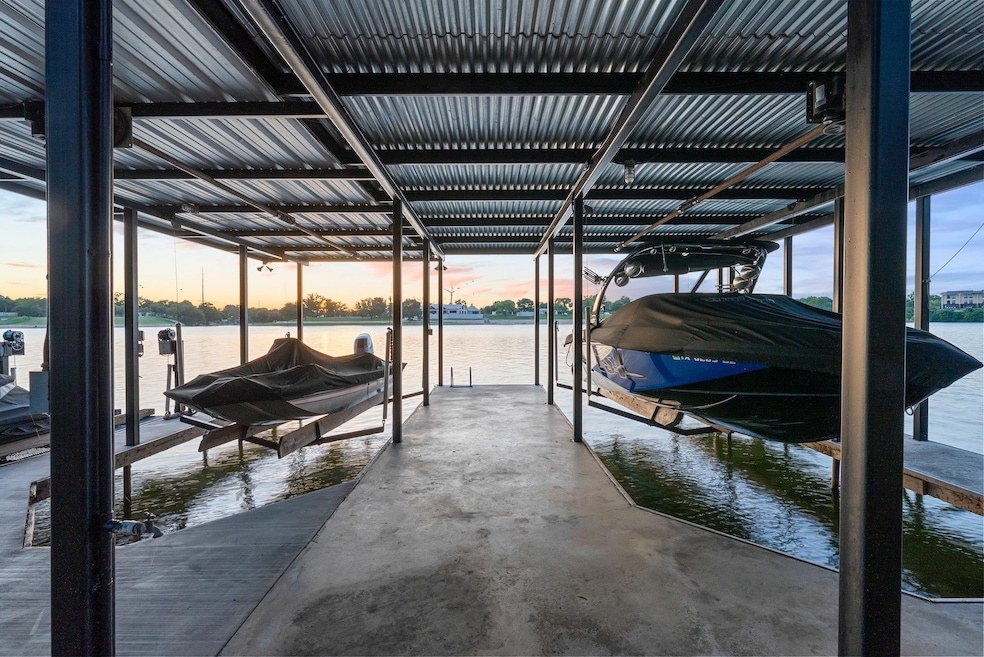 Dock area featuring boat lift and a water view