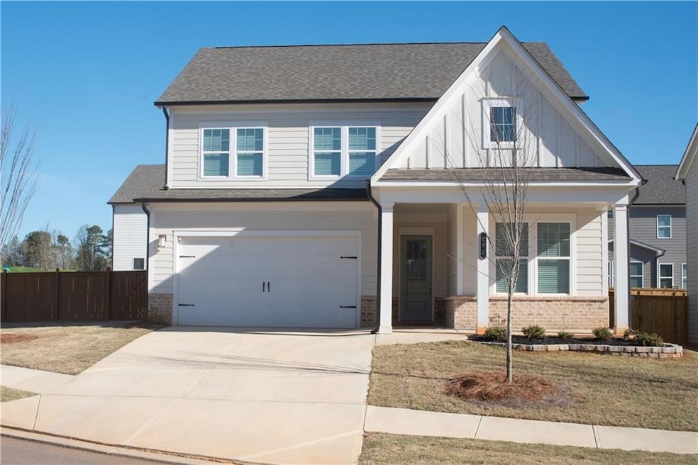 View of front of home with brick siding, concrete 