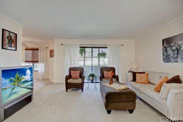 Living room with sliding glass door to covered pat