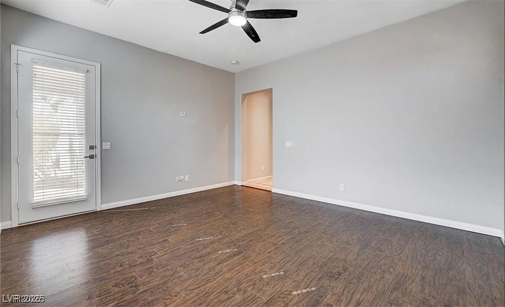 Unfurnished room with ceiling fan, wood finished f