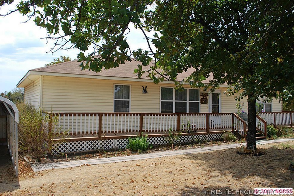 FRONT OF HOUSE, ALMOST FULL PORCH ACROSS.