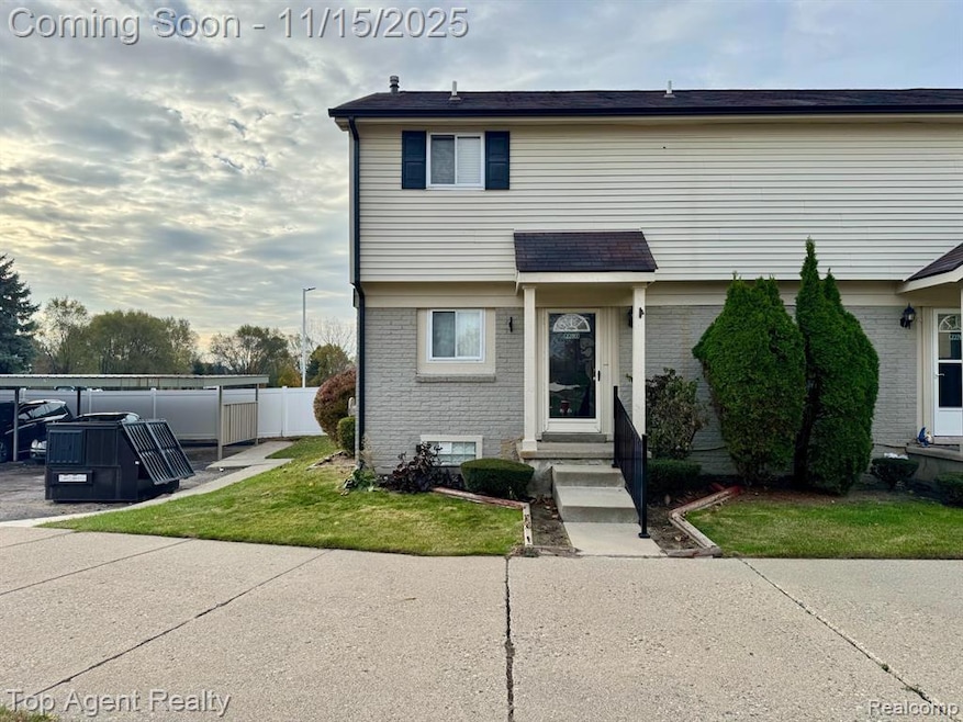 Colonial home featuring brick siding