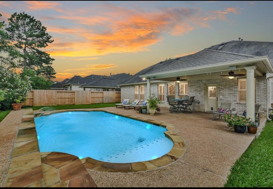 Beautiful backyard with a pool and covered patio.  New pool pump, New filter, and new robotic pool cleaner.