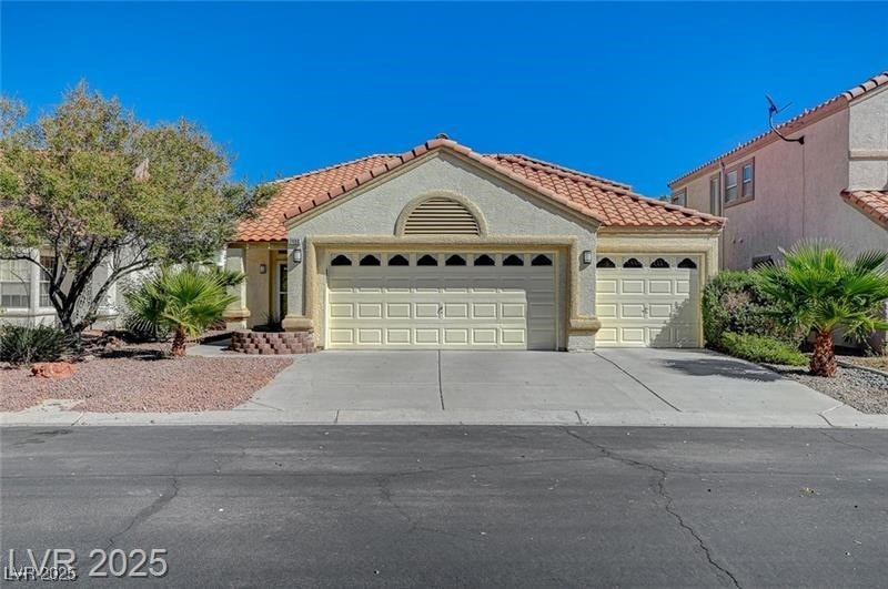 Mediterranean / spanish-style house with a garage,