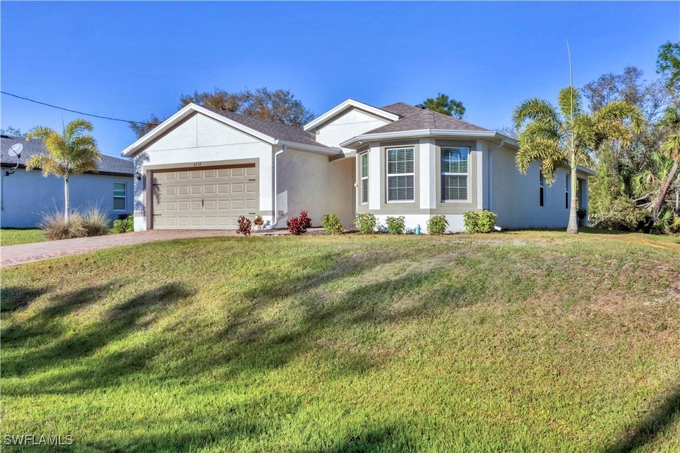 Single story home with a front yard, a garage, and
