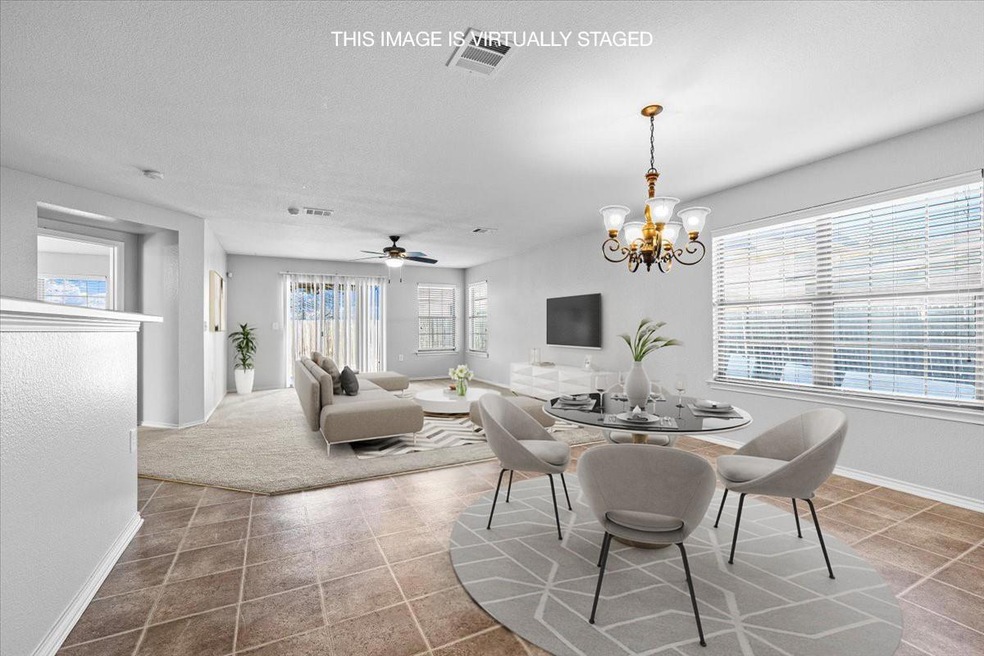 Tiled dining area featuring baseboards, a texture