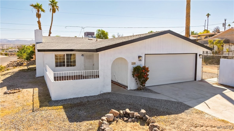 Single story home featuring roof with shingles, st