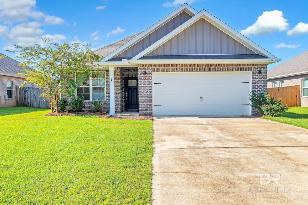 View of front facade with brick siding, board and batten siding, a garage, and concrete driveway