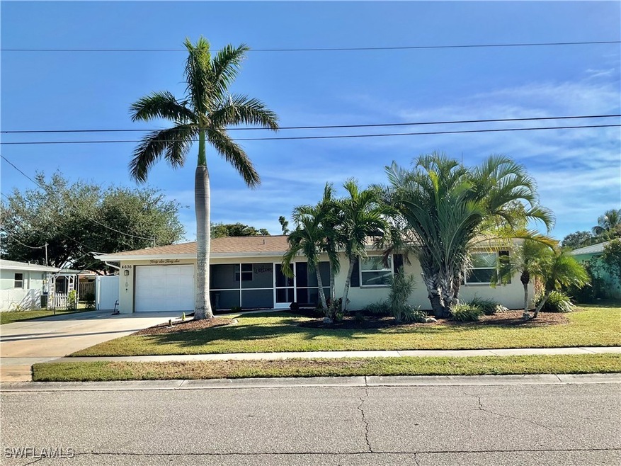 View of front of home with a garage and a front la