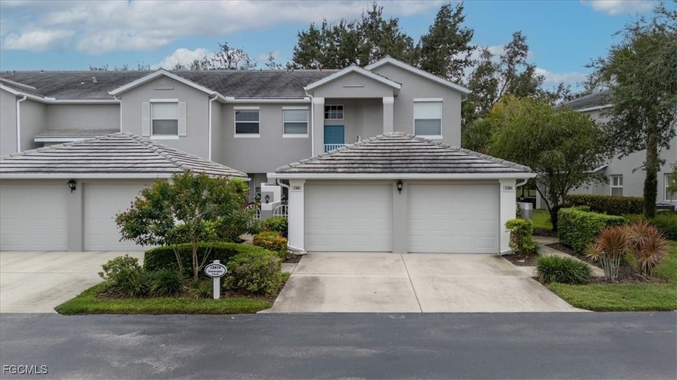 Traditional-style house with stucco siding, driveway, and a garage