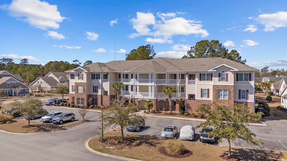 View of property with uncovered parking and a resi