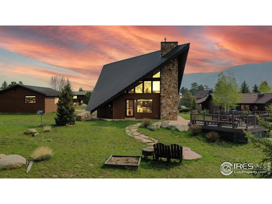 Enjoy the fresh mountain air while looking south on the lovely composite deck that overlooks Longs, Meeker, and Twin Sisters. Roast marshmallows in the permanent fire pit. This photo looks to the northeast.