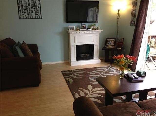 Living room with laminate wood flooring and newer 