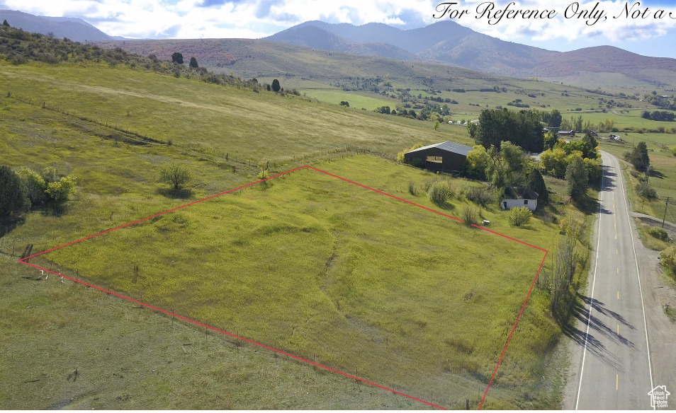 Birds eye view of property with a mountain view and a rural view