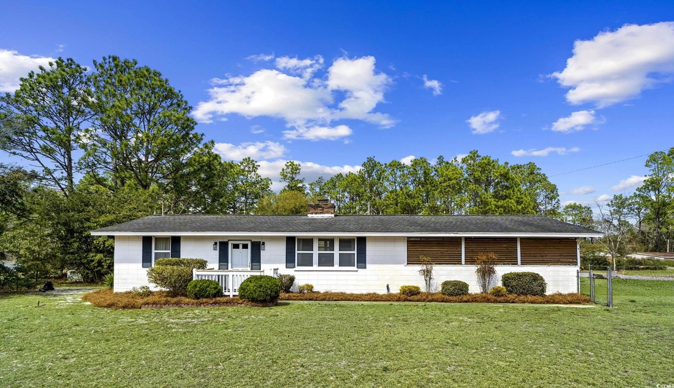 Single story home with a front lawn, covered porch