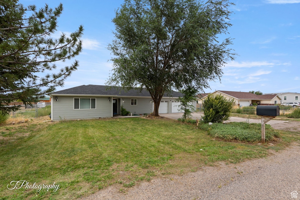 Single story home with driveway and a garage