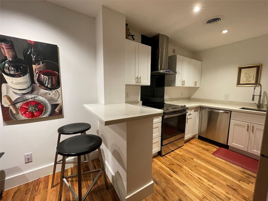 A sleek a fully equipped kitchen featuring stainle