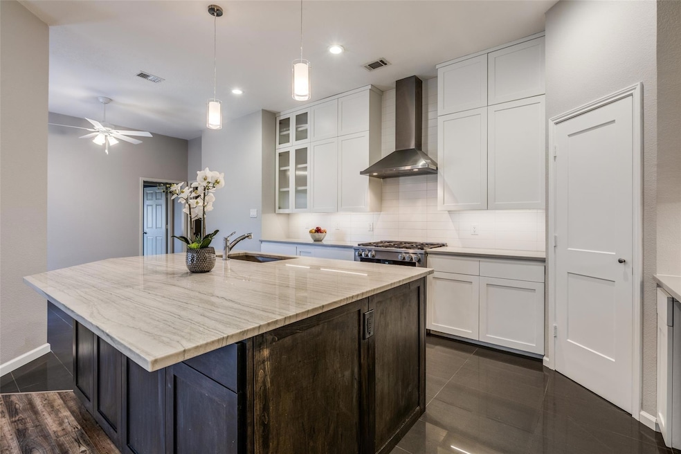 remodeled kitchen with Thermadore gas range, ample cabinet space, pendant lights , storage on both sides of eat in island