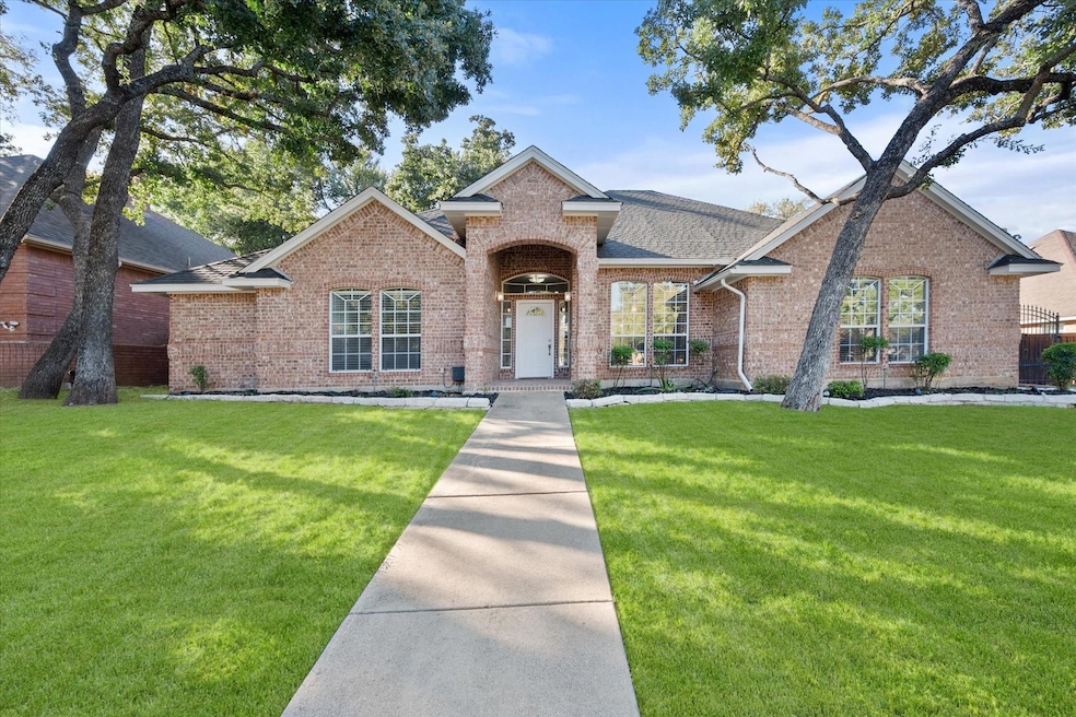 Beautiful mature trees flank the front yard & add 