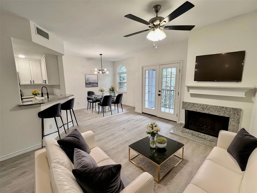 Living room with ceiling fan with notable chandeli