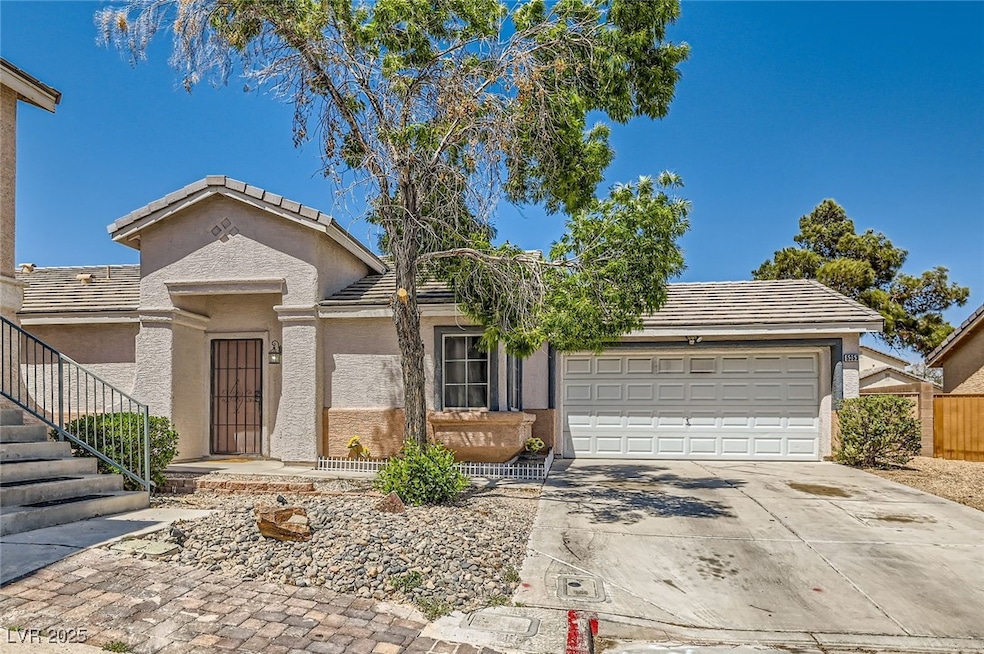 Ranch-style home with driveway, a tiled roof, an a