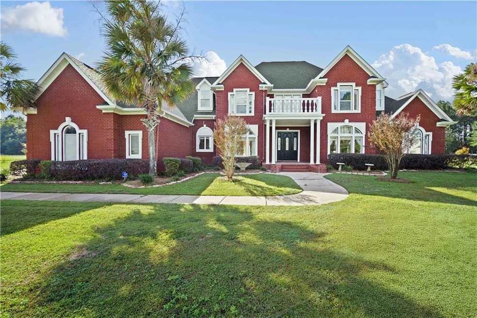 View of front of home with a balcony and a front l