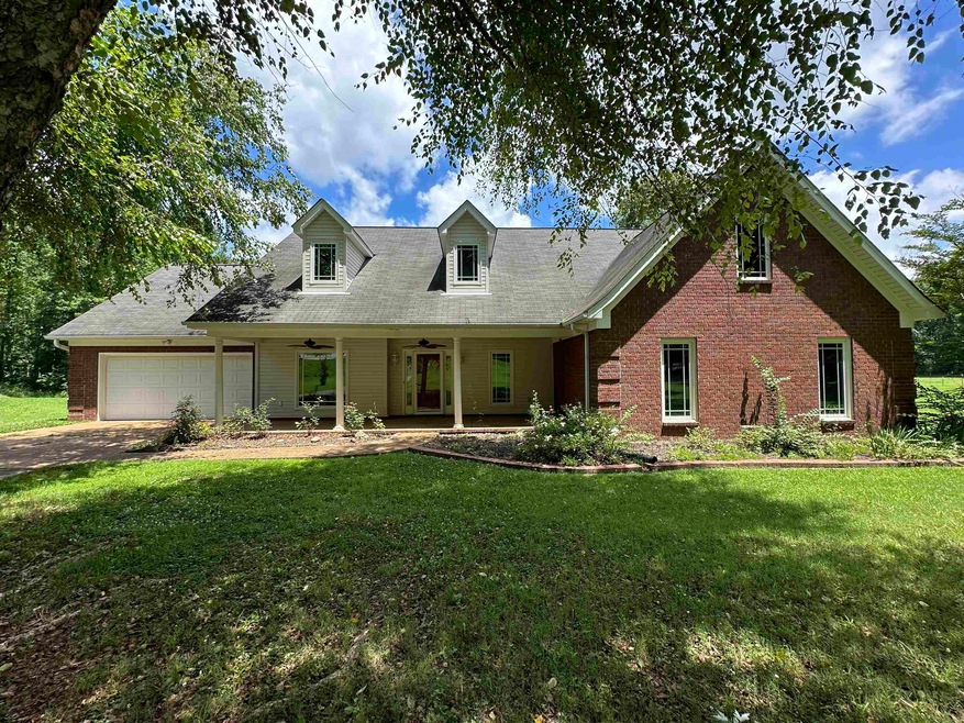 Cape cod home with a garage and a front yard
